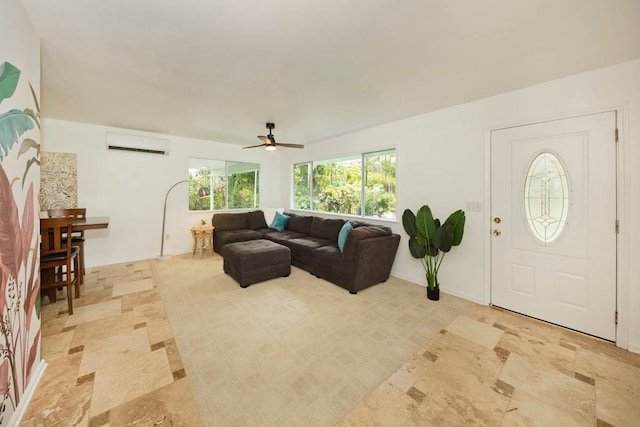 tiled living room featuring a wall unit AC and ceiling fan