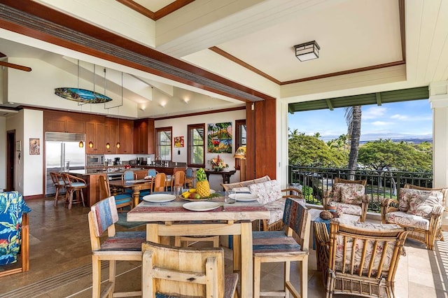 dining area with ceiling fan and dark tile flooring