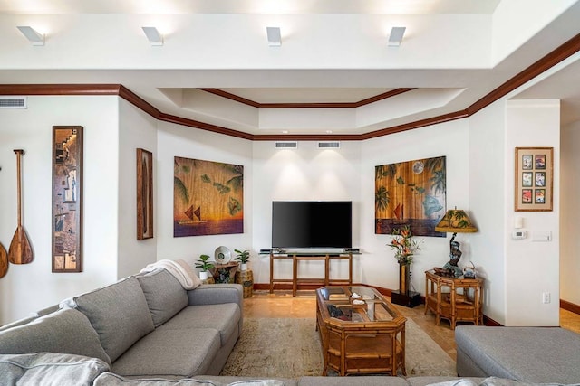 living room featuring a tray ceiling, light tile floors, and crown molding