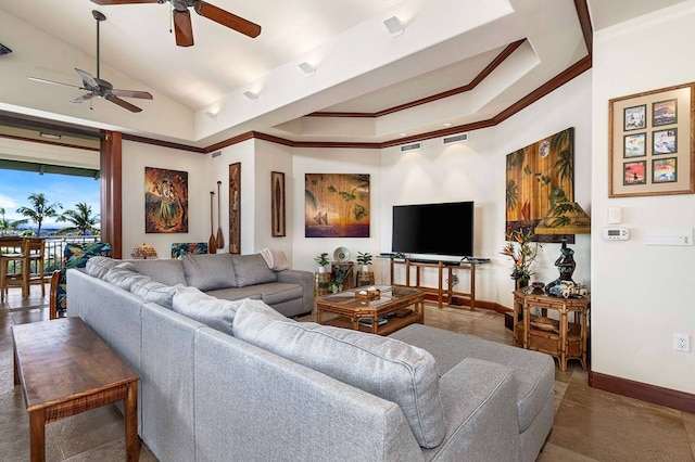 living room featuring dark tile floors, ceiling fan, and lofted ceiling