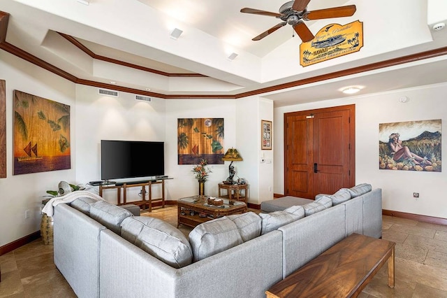 living room featuring ceiling fan, dark tile floors, and a raised ceiling