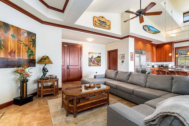 tiled living room featuring ceiling fan, sink, and a high ceiling