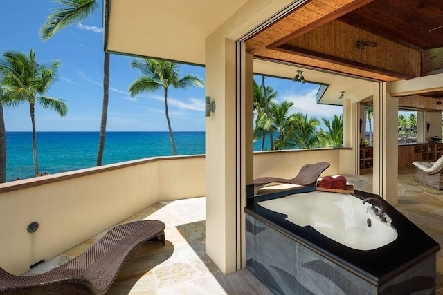 interior space featuring a water view, wooden ceiling, and tile flooring