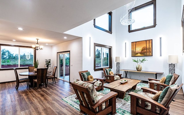 living room with dark hardwood / wood-style flooring, a chandelier, and plenty of natural light