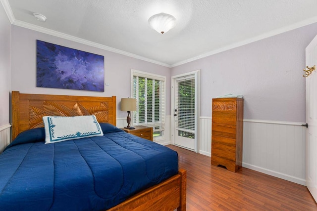 bedroom with access to outside, crown molding, and dark wood-type flooring