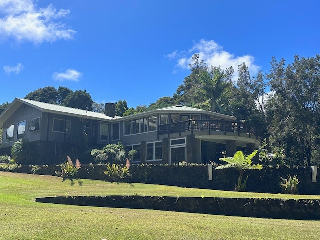 view of side of home with a yard