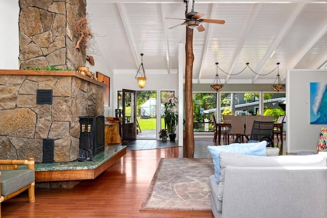 living room with beam ceiling, wood ceiling, a fireplace, and ceiling fan