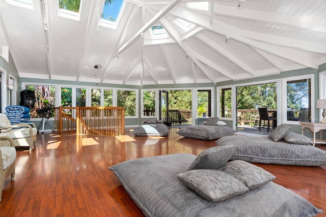 living room with beam ceiling, a healthy amount of sunlight, and a skylight