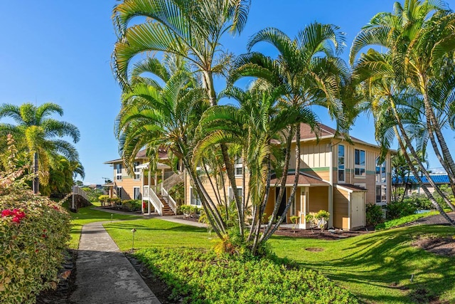 view of side of home with a lawn