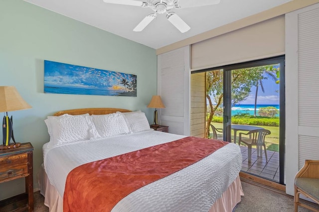 carpeted bedroom with a water view, ceiling fan, and access to outside