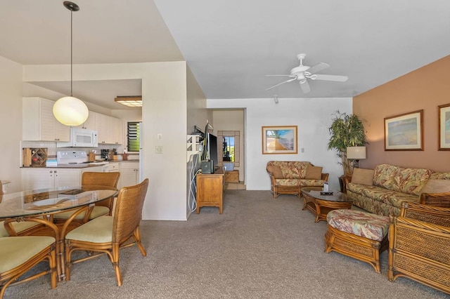 carpeted dining room featuring ceiling fan