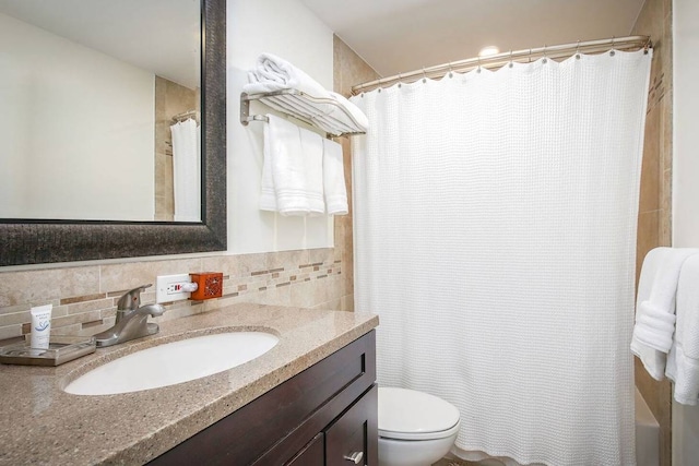 bathroom with tile walls, backsplash, toilet, and large vanity