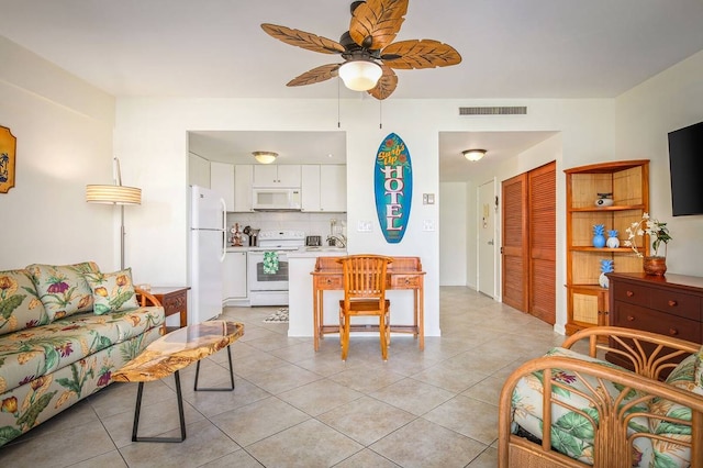 tiled living room with ceiling fan