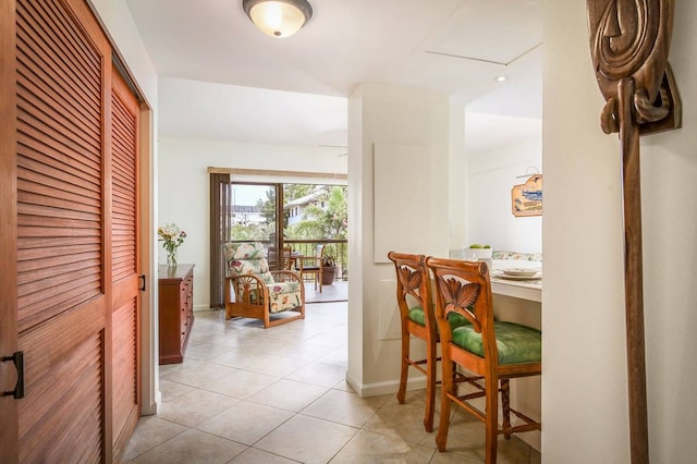 hall featuring light tile flooring