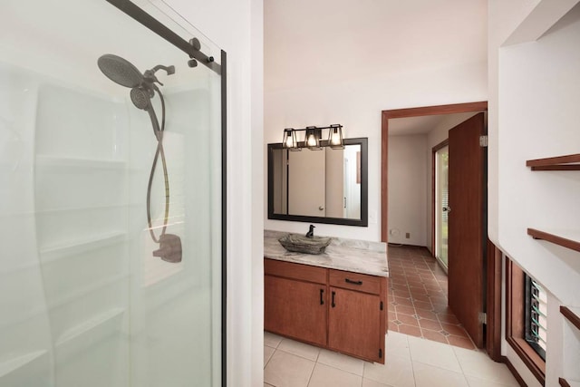 bathroom featuring a shower, vanity, and tile floors