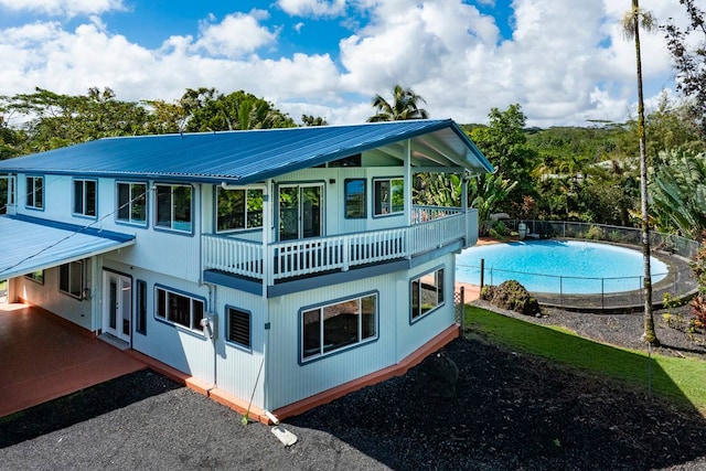 rear view of house featuring a balcony