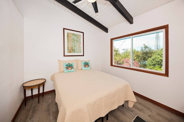 bedroom featuring lofted ceiling with beams, dark hardwood / wood-style floors, and ceiling fan