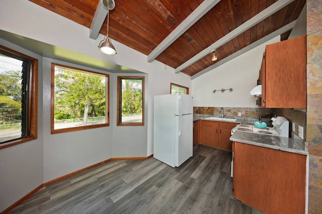 kitchen with white refrigerator, plenty of natural light, and wood ceiling