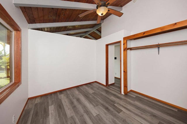 unfurnished bedroom featuring ceiling fan, a closet, dark hardwood / wood-style flooring, vaulted ceiling with beams, and wood ceiling