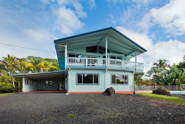 exterior space with a swimming pool, a balcony, and ceiling fan