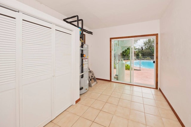 interior space featuring light tile flooring and water heater