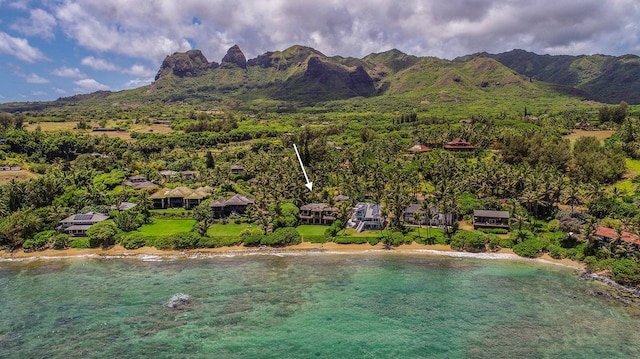 birds eye view of property featuring a water and mountain view and a beach view