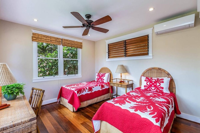 bedroom with a wall mounted air conditioner, ceiling fan, and dark wood-type flooring