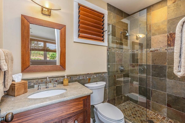 bathroom featuring toilet, tile walls, vanity with extensive cabinet space, backsplash, and an enclosed shower