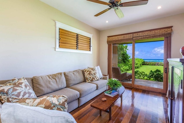 living room with dark hardwood / wood-style floors and ceiling fan