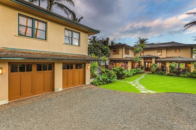 view of front of property featuring a front yard and a garage