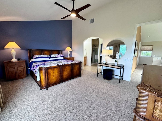 carpeted bedroom featuring ceiling fan and high vaulted ceiling