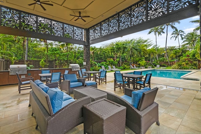 exterior space featuring grilling area, outdoor lounge area, ceiling fan, an outdoor kitchen, and a fenced in pool