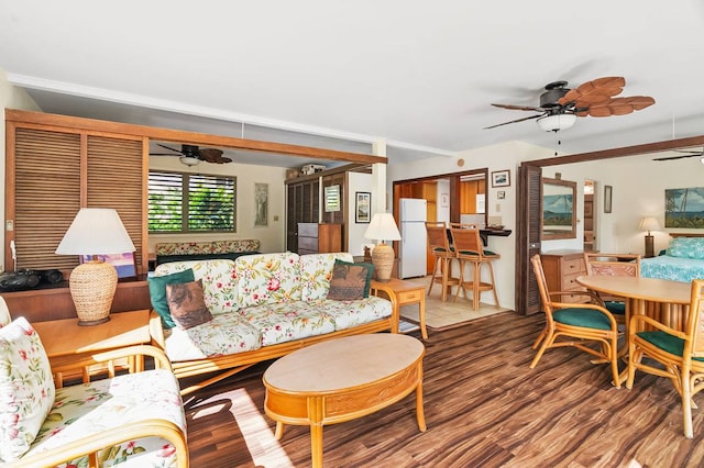 living room featuring ceiling fan and dark hardwood / wood-style flooring