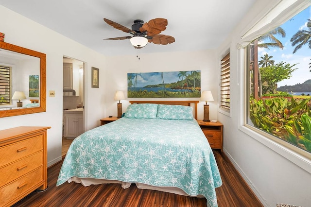 bedroom with ensuite bath, ceiling fan, and dark hardwood / wood-style floors