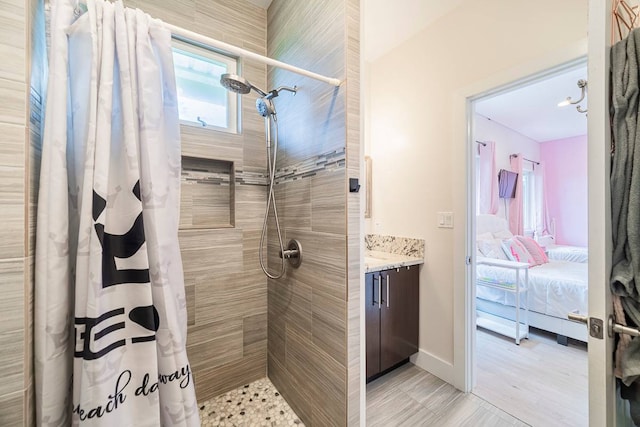 bathroom featuring tile flooring, vanity, and a shower with curtain