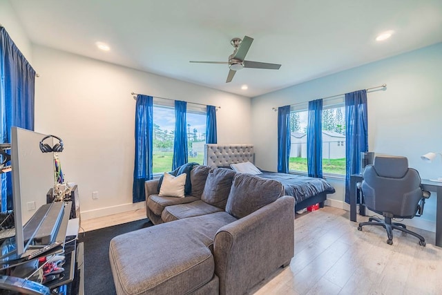 bedroom with ceiling fan and light hardwood / wood-style flooring