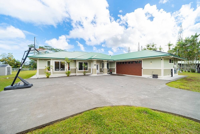 view of front of home with a front lawn and a garage