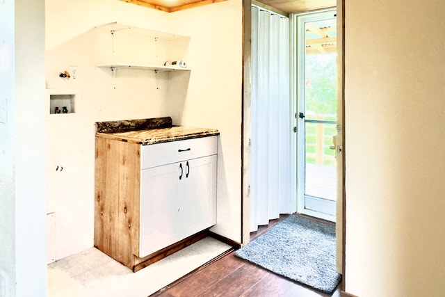 interior space featuring light hardwood / wood-style floors and white cabinets