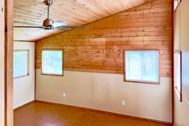 spare room featuring wood ceiling, a wealth of natural light, ceiling fan, and lofted ceiling