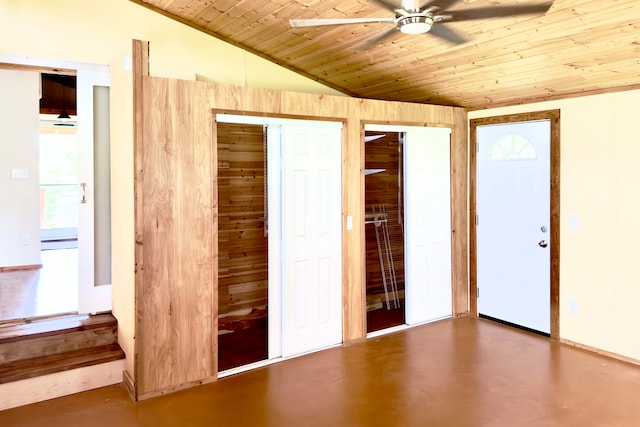 unfurnished bedroom featuring wood ceiling, vaulted ceiling, ceiling fan, and two closets