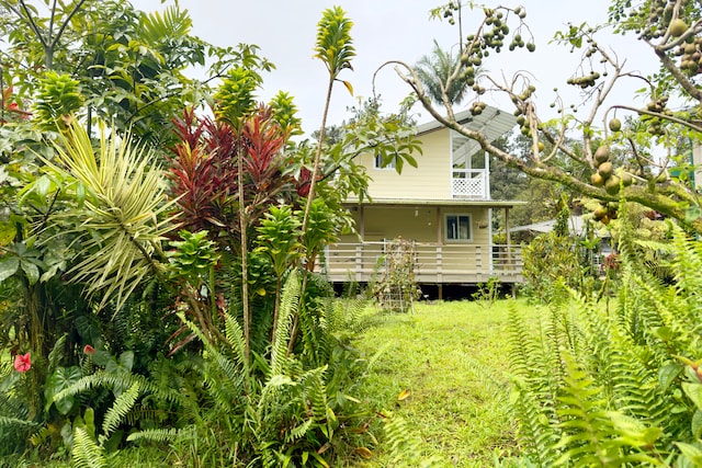 view of property exterior featuring a deck and a lawn