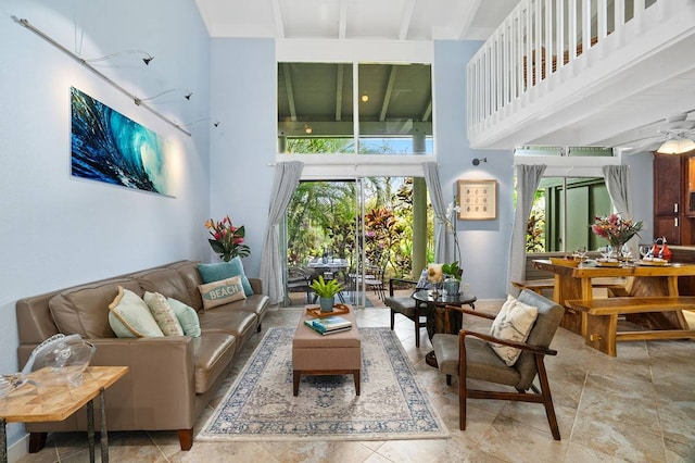 interior space with ceiling fan and beam ceiling