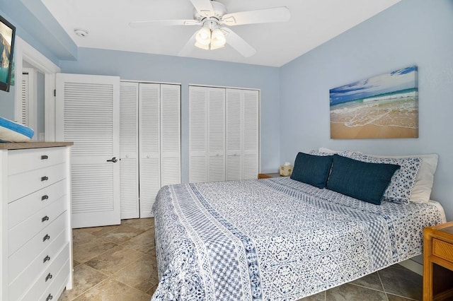 bedroom featuring multiple closets, ceiling fan, and light tile floors