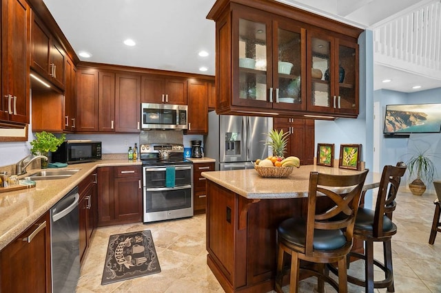 kitchen featuring light tile floors, light stone counters, sink, and stainless steel appliances