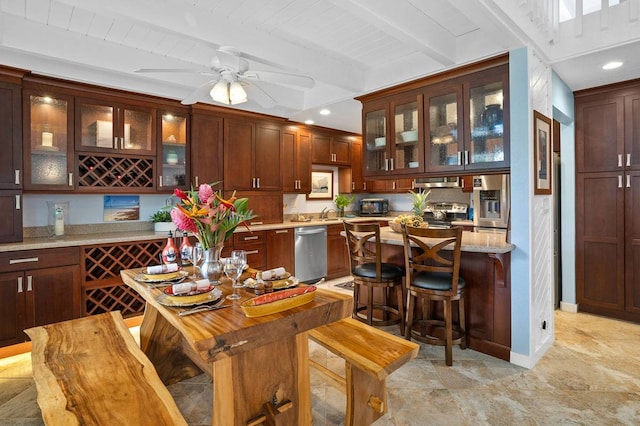 bar featuring stainless steel dishwasher, light tile flooring, beamed ceiling, light stone counters, and ceiling fan