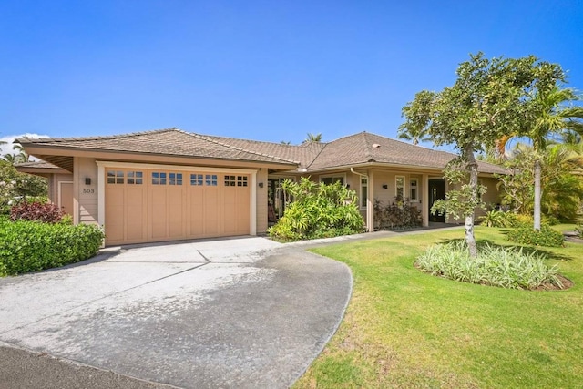 view of front of house with a garage and a front yard