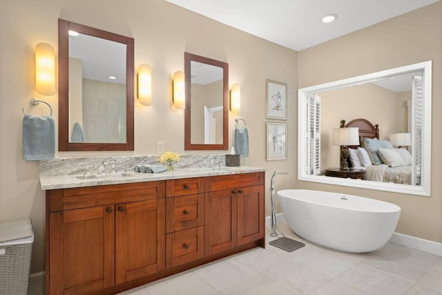 bathroom with tile patterned floors, a tub to relax in, decorative backsplash, and vanity