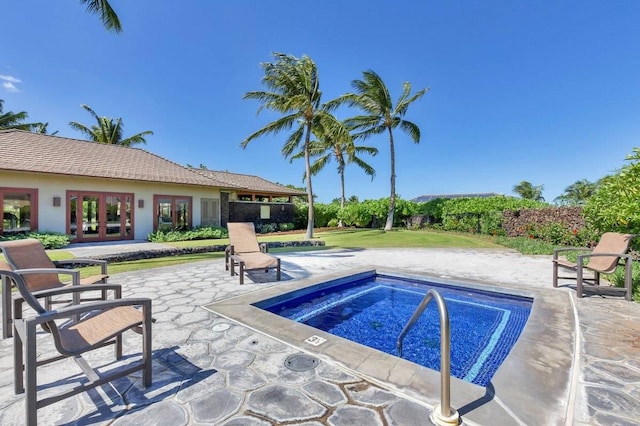 view of pool featuring a patio area, french doors, and an in ground hot tub