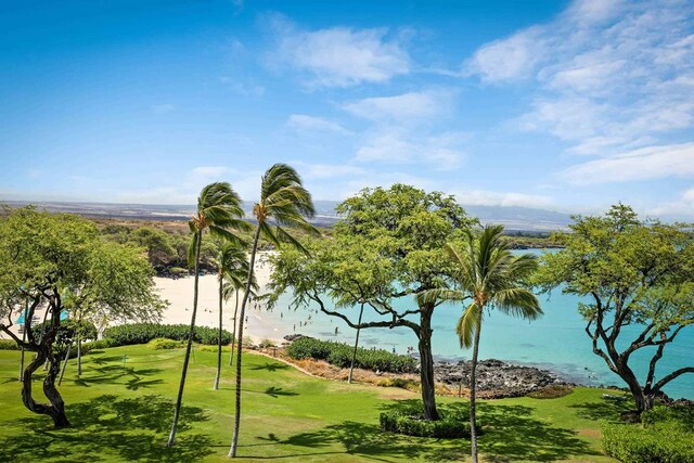 view of home's community with a water view and a yard