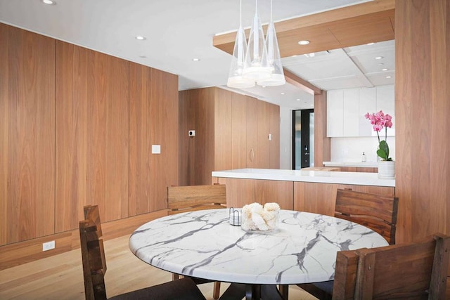 kitchen featuring decorative light fixtures, white cabinetry, and a center island